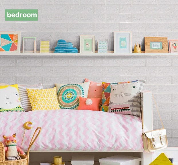 White 3D brick wall sticker applied in a colorful kids’ bedroom with playful cushions and framed prints