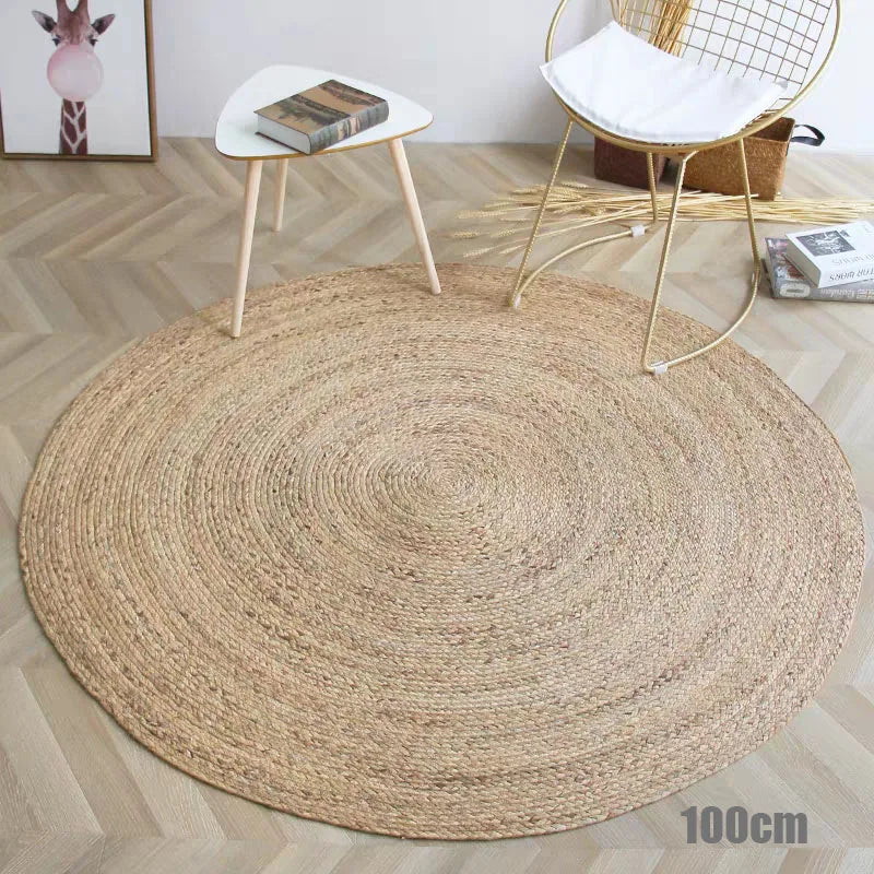 Round straw rug placed beside a white chair and small table in minimalist room