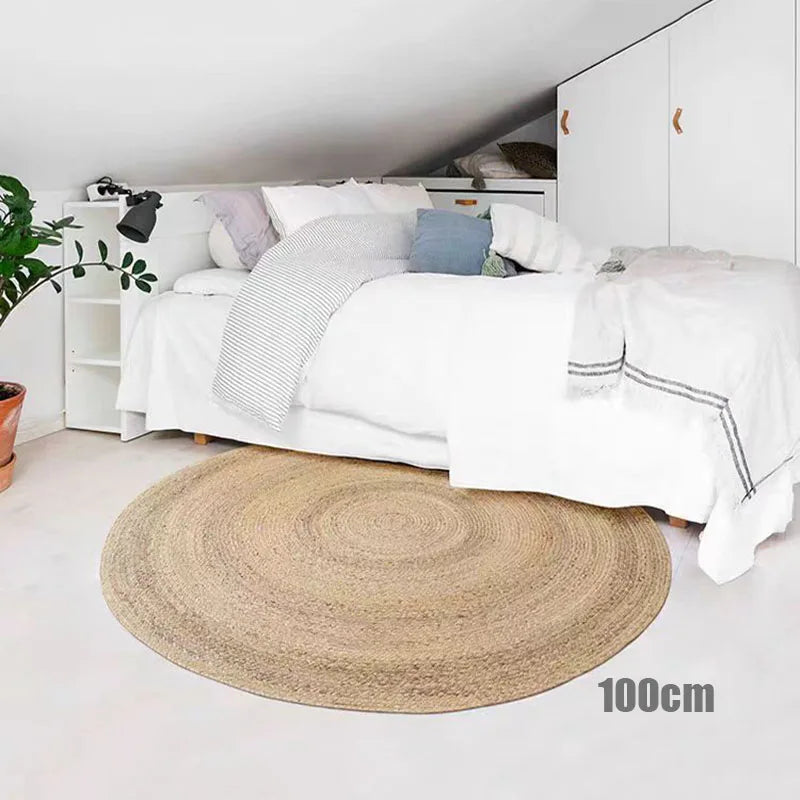Round straw rug placed under a bed for cozy bedroom decor
