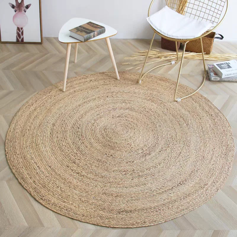 Natural reed round rug styled with minimalistic white chair