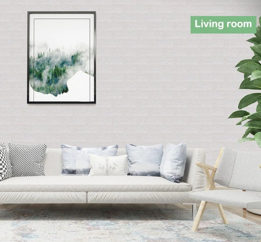 White 3D brick self-adhesive foam wallpaper installed in a modern living room with a neutral sofa and framed artwork