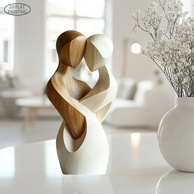 Wooden couple statue displayed next to white ceramic vase