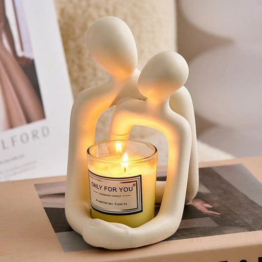Resin couple statue used as a candle holder on a bedside table